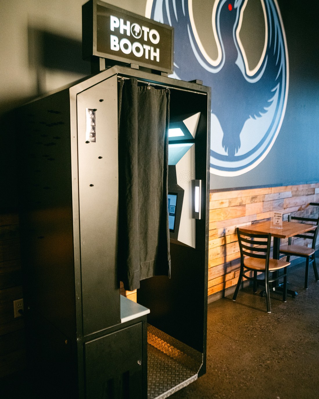 The enclosed booth installed against the wall of a taproom