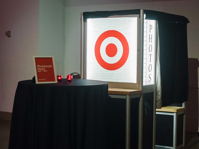 Enclosed booth with a corporate logo on its light box