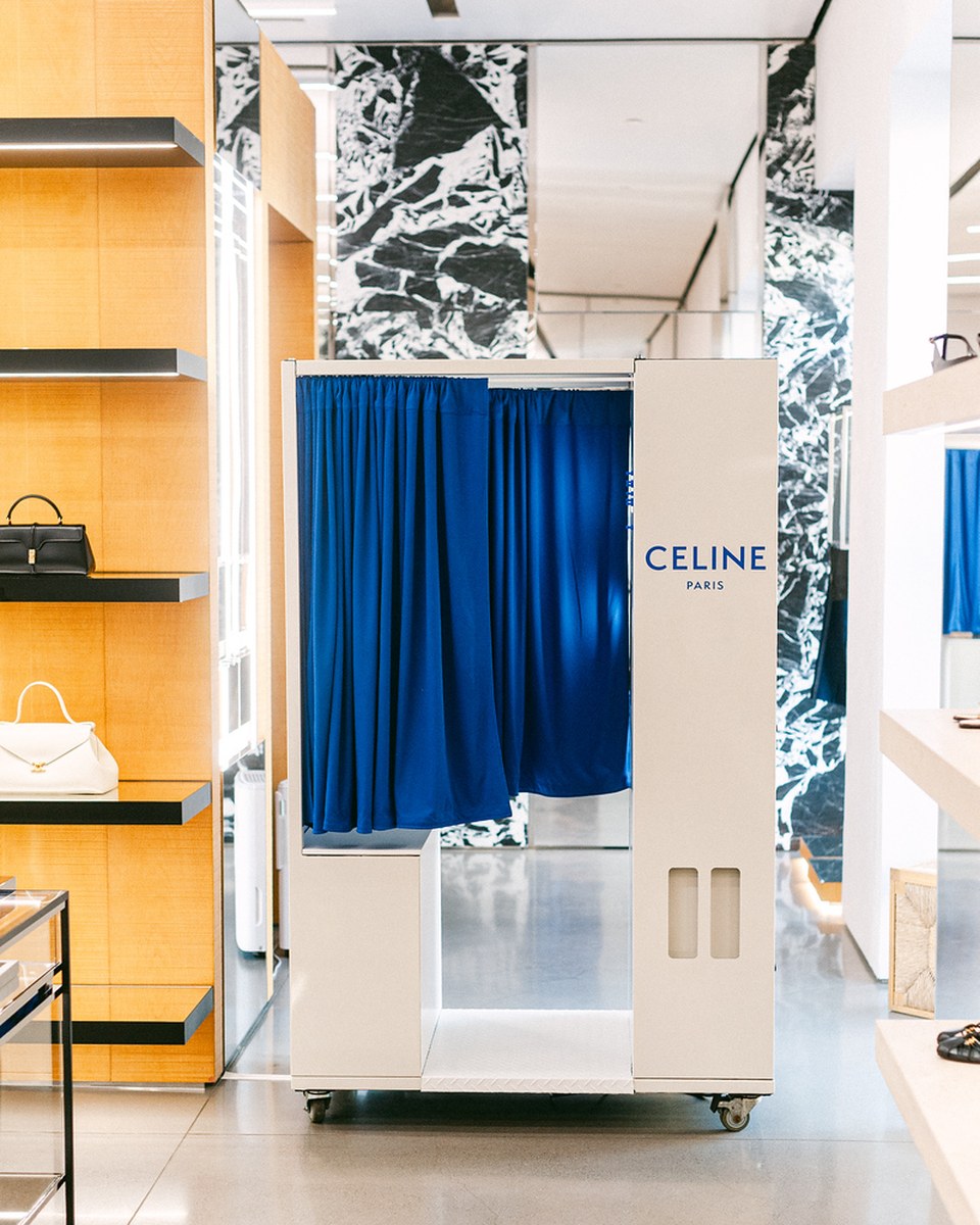 Enclosed booth wrapped in custom artwork with a Passport Photos sign